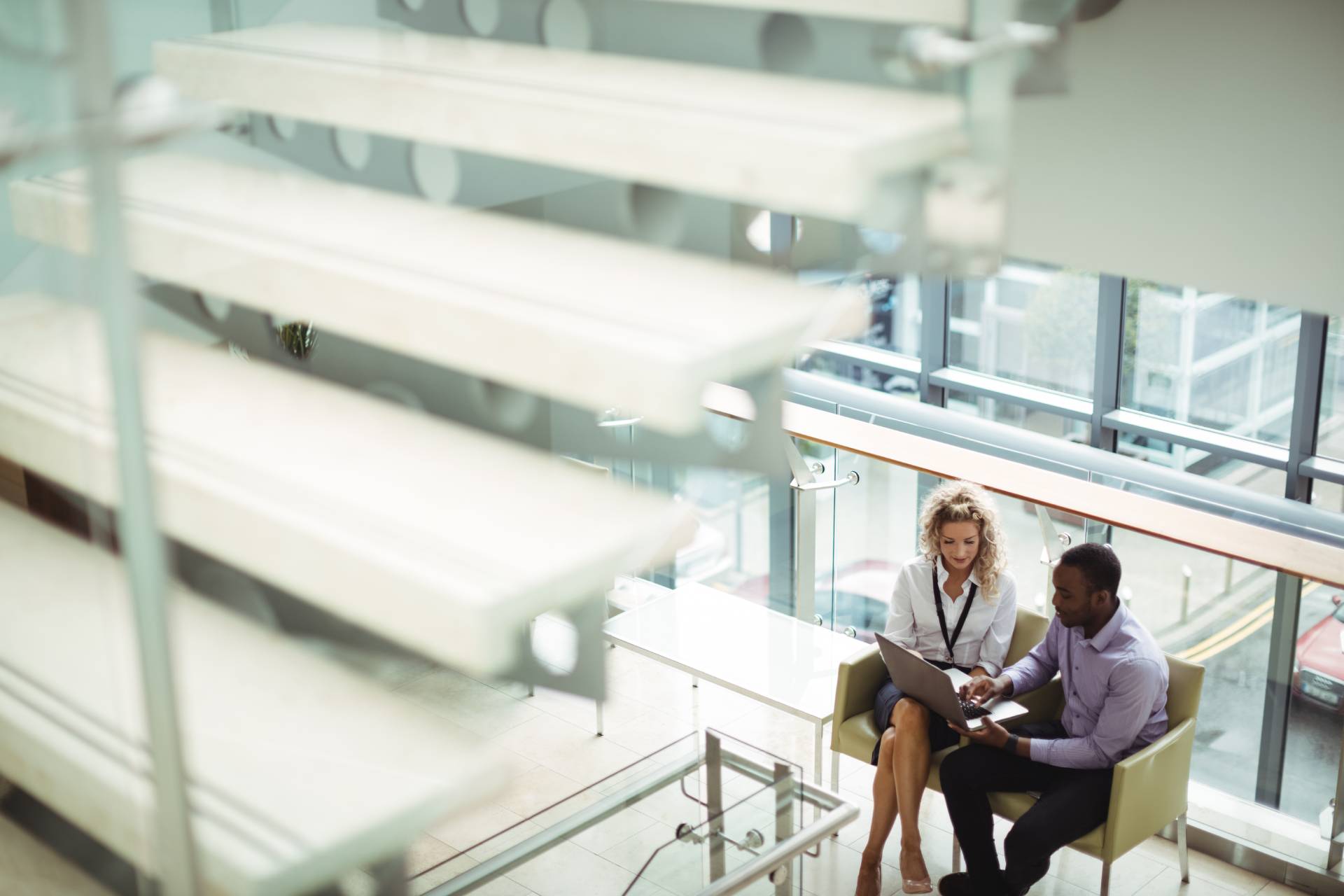 Male and female colleague walking in the offices of Alisef Blue Redburn